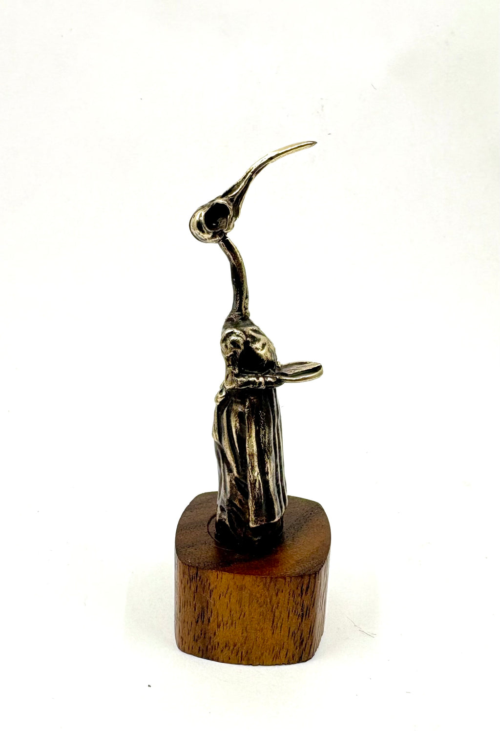 Bronze sculpture of a hummingbird  figure with a long neck on a wooden base 
